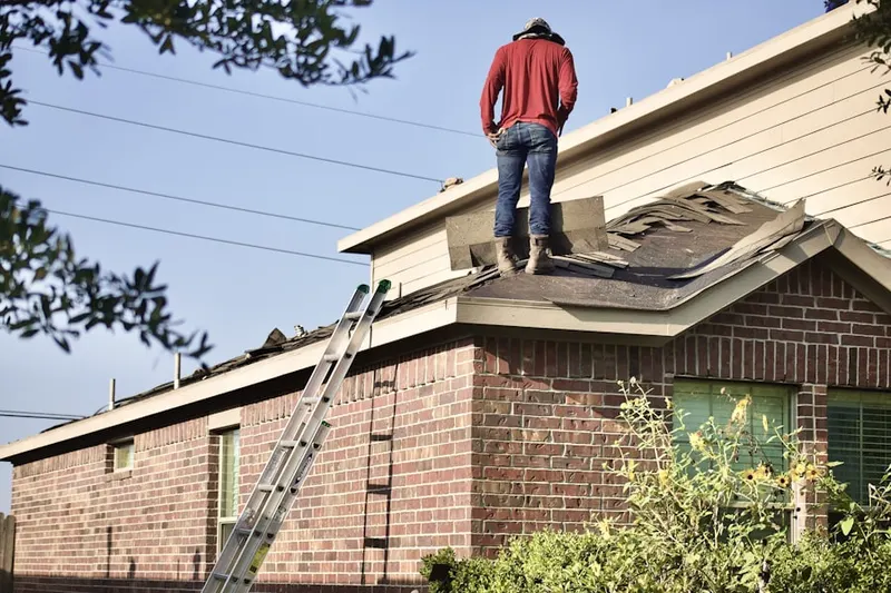 Professional roofer working on a residential roof in Oak Glen